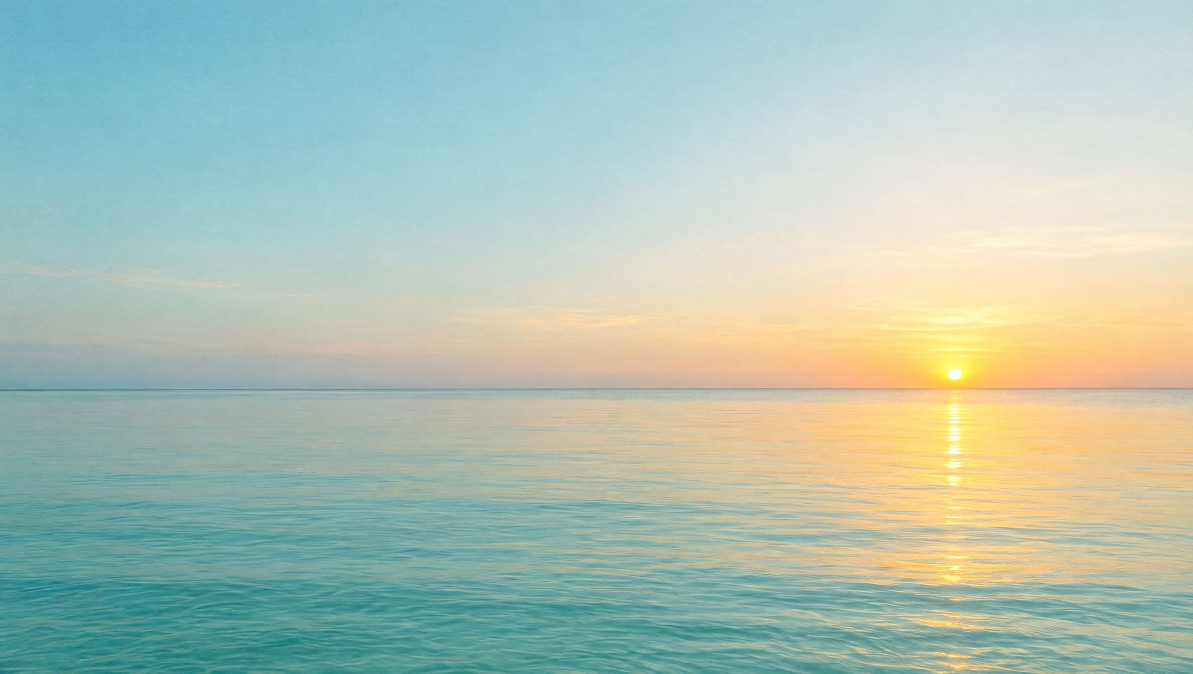 Calm Gulf water at sunrise, with a low gold sun resting on a flat horizon